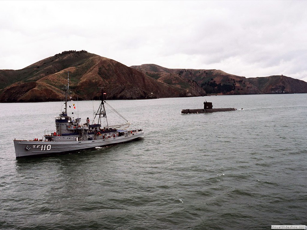 USS Nautilus (SSN-571) under tow near the Golden Gate Bridge during 1985.