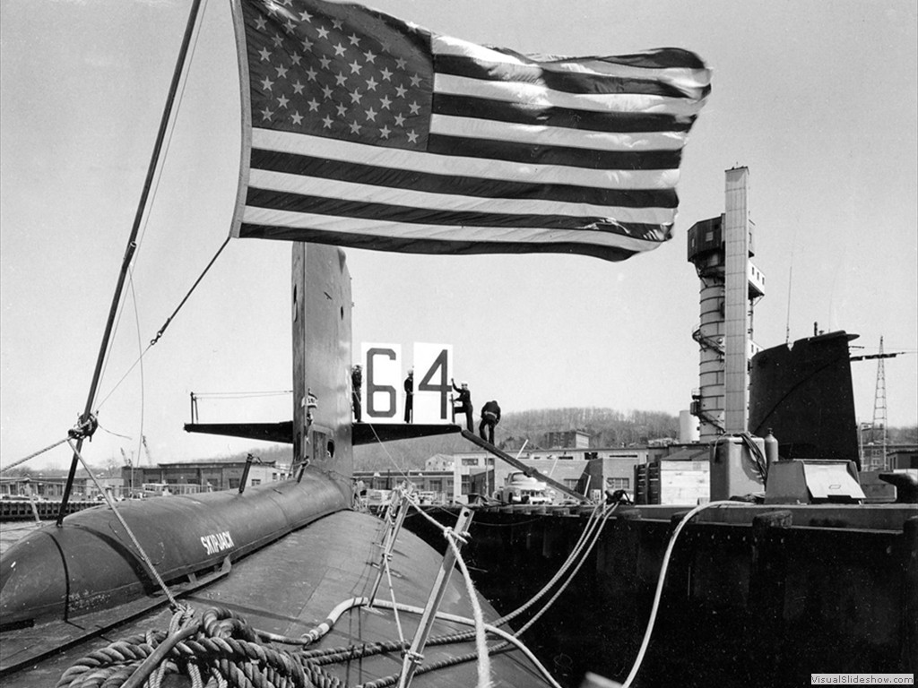 USS Skipjack (SSN-585) tied up to a pier at the submarine base, Groton, CT, 1964.